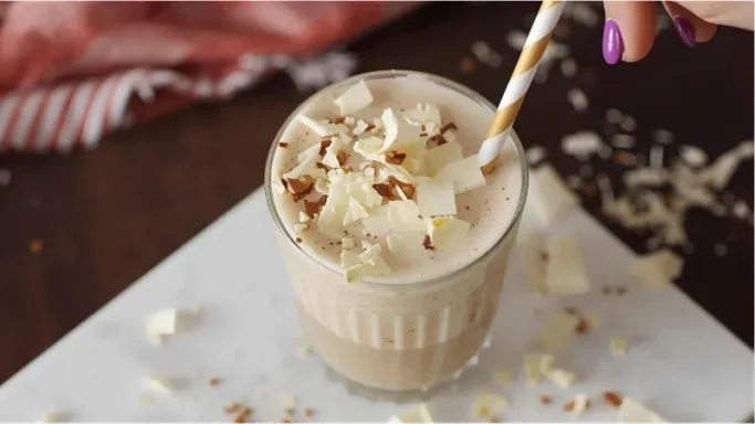 Sprinkle some white chocolate shavings on top for a touch of elegance. Insert a straw and take that first sip—you've earned it!